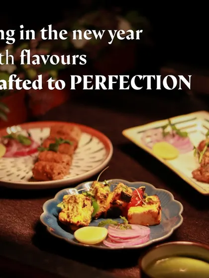 A spread of modern Indian appetizers, including various kebabs and tikkas.