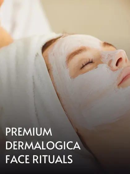 A close-up of a client enjoying a Premium Dermalogica Face Ritual. The thick, nourishing mask is applied to deliver potent ingredients directly to the skin, promoting a clear and calm complexion.