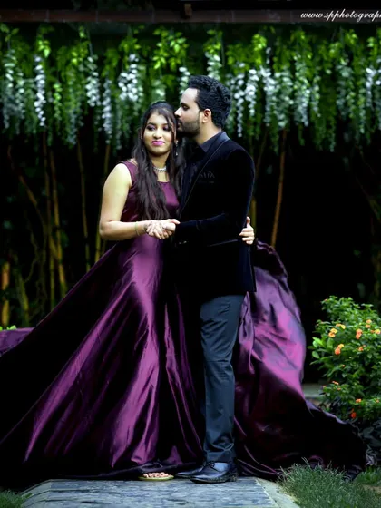 A glamorous pre-wedding portrait set in a lush garden. The bride's flowing gown and the romantic pose create a look of pure elegance and sophistication.