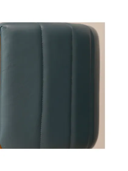 Another detail of the accent chair, focusing on the rich texture of the leather upholstery. This chair is designed to be a centerpiece that reflects your personal style.