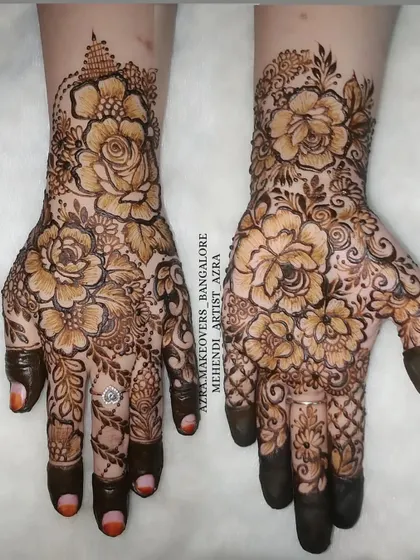 The same bold Arabic floral design, showing the consistency and detail across both hands.