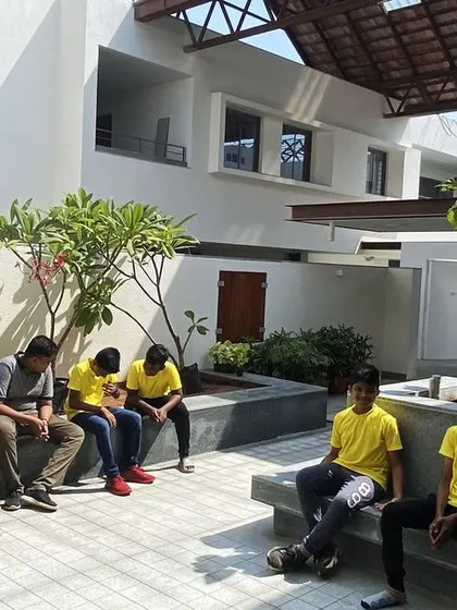 Students at Vellore International School gather in an open-air courtyard. The residential wing is designed as clusters of rooms around these courts to create a sense of a smaller, family-like unit within the larger school.