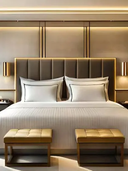 A hotel-style luxury bedroom with a sophisticated, panelled wall behind the bed. I used metallic accents and symmetrical lighting to create a formal and elegant design.