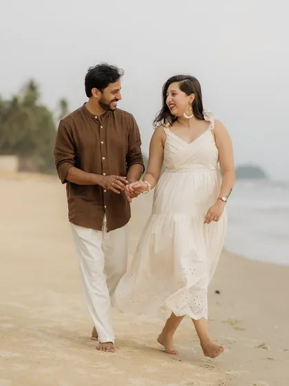 A romantic walk on the beach. We capture these simple, shared moments during pre-wedding shoots to tell a story of companionship and love.