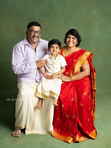 A heartwarming portrait of a grandson with his grandparents, all in traditional South Indian attire. It's a beautiful three-generation photograph full of love.