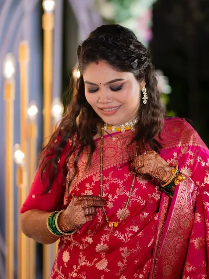 A candid moment of the bride adjusting her mangalsutra. The makeup is designed to look beautiful and natural in every shot.