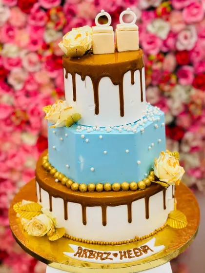 The full view of the stunning three-tiered engagement cake, a perfect centerpiece for a special celebration.