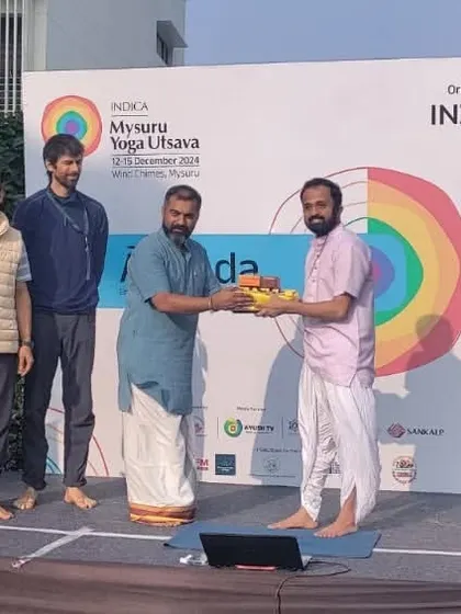 Receiving a token of appreciation at the Mysuru Yoga Utsava. It is always a pleasure to connect with other organizations and teachers who are dedicated to spreading the authentic message of yoga.