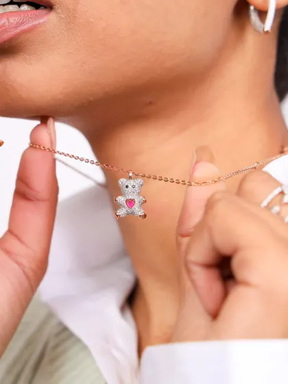 A close-up on a charming teddy bear pendant from Diamond Jewel. This image focuses on the product's unique design and emotional appeal, making it perfect for gift-giving campaigns.