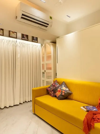 With the wall bed folded up, the room transforms into a cozy living area or office space. This is the kind of smart, flexible design we love to create for our clients.