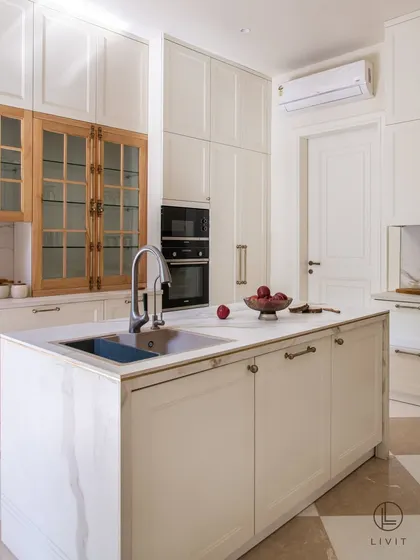 A well-appointed kitchen is the heart of the home, and its details matter. In this stunning residence, our Sphere cabinet pulls and Cremone bolts in an Antique Brass matte finish provide a warm, metallic counterpoint to the clean white cabinetry and natural wood. It is a testament to how the right hardware can elevate a space from functional to exceptional.