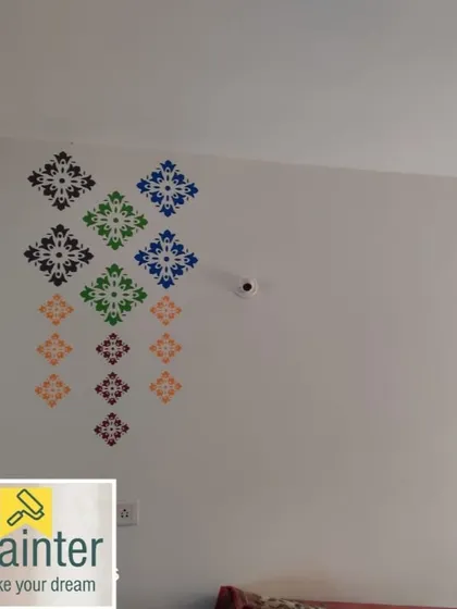 A geometric arrangement of colorful stenciled motifs on a plain white wall. This is a simple way to add a pop of color and pattern to a minimalist space.