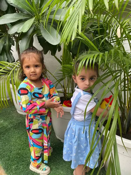 A candid moment of our little ones tending to the plants. These hands-on nature activities are an integral part of our curriculum.