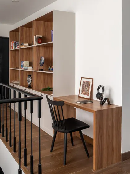 We incorporated a study nook into the family lounge, complete with a built-in bookshelf. This functional addition provides a quiet spot for work or reading without interrupting the flow of the space.
