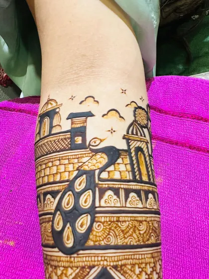 A close-up of one of my favorite arm pieces from this season, featuring a majestic peacock on a palace balcony.