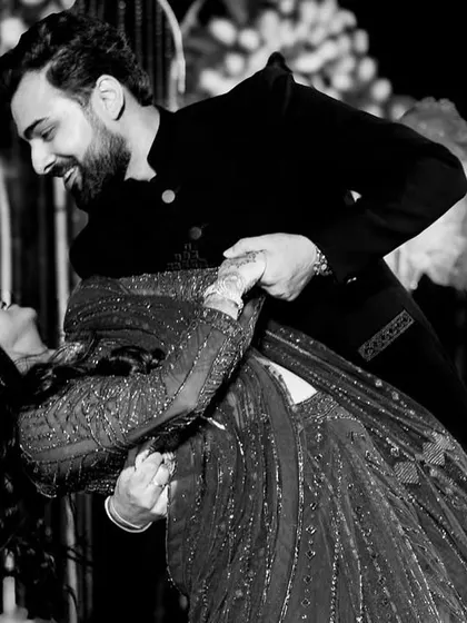 A classic ballroom dip is always a showstopper. This black and white photo captures the elegance and romance of this timeless move in their wedding dance.