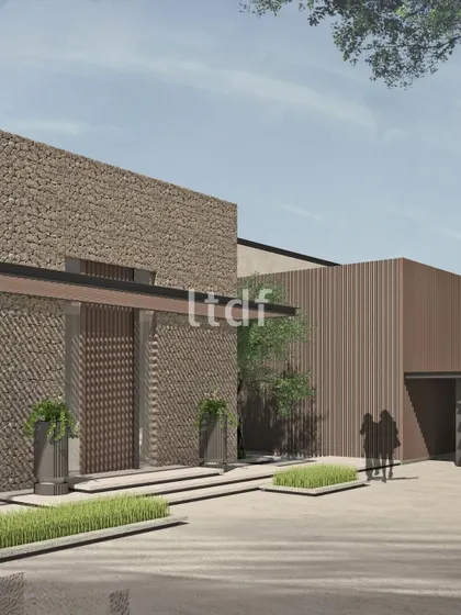 This design explores the beauty of rugged textures in a modern context. The extensive use of stone cladding on the facade creates a powerful, almost monolithic presence, balanced by the clean lines of the contemporary architectural form.