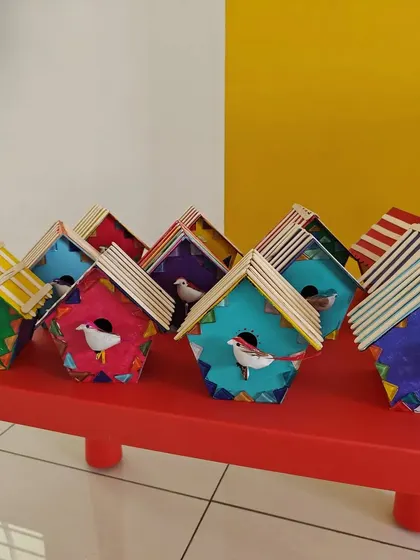 Another look at the finished birdhouses, showcasing the imaginative color combinations the kids came up with.