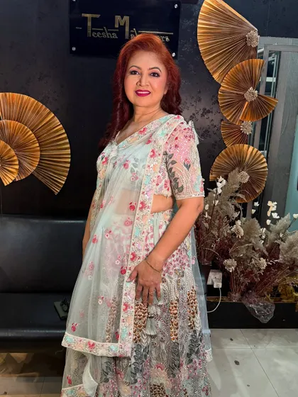 A full-length shot of the mom in her floral lehenga, looking absolutely stunning.