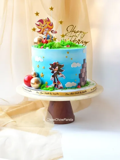 A slightly different perspective of the Choco Mousse Sonic cake, highlighting the "Happy Birthday" topper and star decorations.