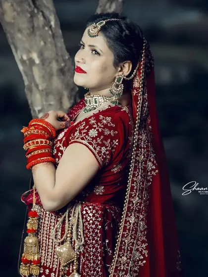 A side profile of the bride, highlighting her intricate hair, makeup, and jewelry. This type of shot is essential for capturing the complete bridal look.