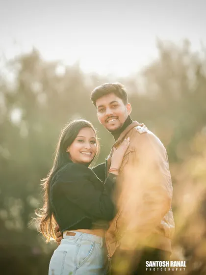 A bright and airy portrait with a creative foreground blur, focusing on the couple's happy expressions.