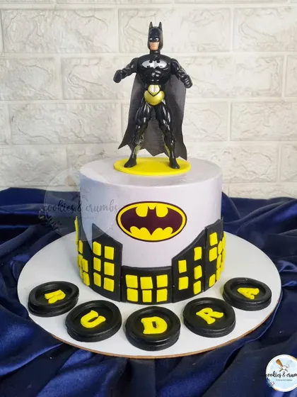 A classic Batman themed cake for a young superhero fan. The Gotham city skyline and Bat-Signal create a cool and iconic look.