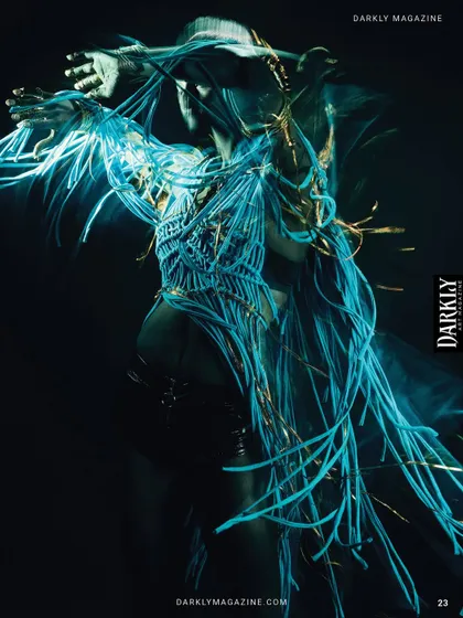 A long-exposure shot from "Divine Frequency," capturing the movement of the glowing tassels.