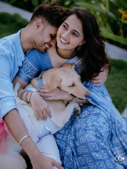 A heartwarming portrait of a couple embracing their beloved dog, all three sharing a moment of pure happiness.