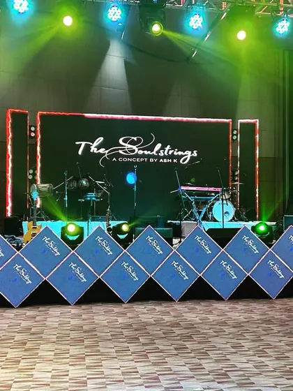 The stage setup for a live band at a Roka ceremony, featuring a large LED screen and branded sound monitors, ensuring professional-grade entertainment.