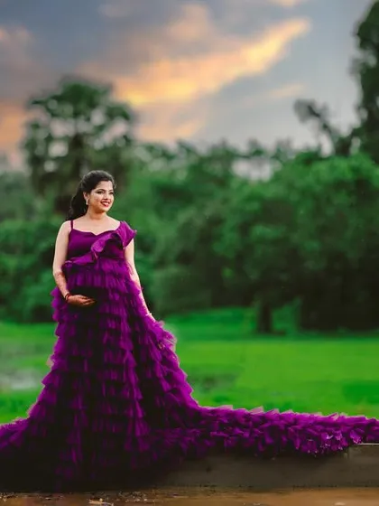 A stunning outdoor shot of our purple ruffle gown. This dress is available in four colors and is perfect for maternity shoots.