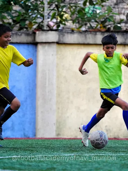 Two players race for the ball in a practice match. I encourage a high-tempo, energetic style of play.