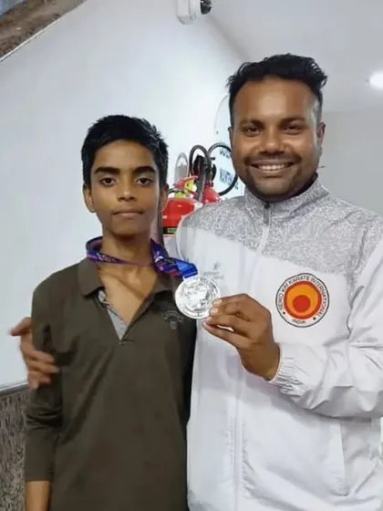 A proud moment for our student Shiva and me, holding the silver medal he won at the nationals.