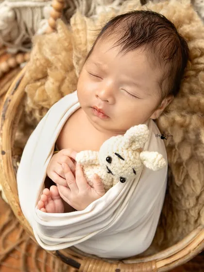 A simple and pure moment of a newborn snuggling with a tiny crocheted teddy bear. I use neutral tones and soft textures in my boho themed setups to keep the focus entirely on your baby.