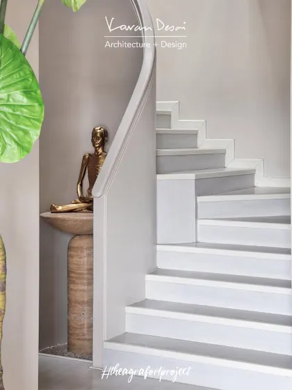 The bronze Pratima sits on a custom-designed travertine console from my Matilda collection. We used focused lighting to highlight the statue and create a serene focal point.