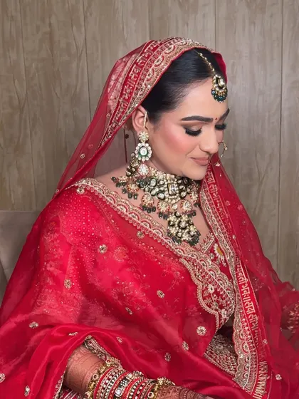 A side profile showcasing the elegant hair and makeup. The soft contouring and defined eyes create a beautiful, sculpted look that photographs perfectly.