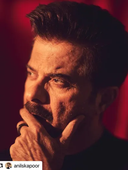 An up-close and personal shot of Anil Kapoor. The lighting highlights the details of his sharp haircut.
