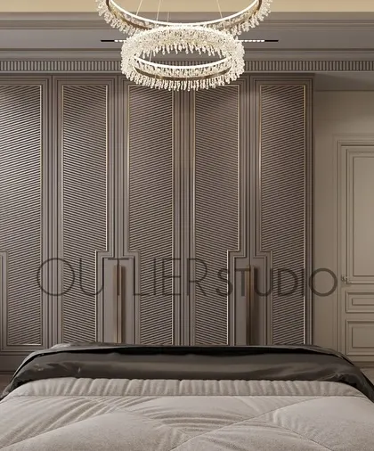 This bedroom is a world of contrasts, with soft light and deep shadows. The design features classic wall mouldings and a full wall of wardrobes, creating a clean, uncluttered, and elegant look.