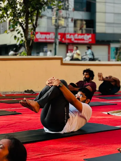 Another angle of our members practicing the wind-relieving pose, a great way to relax and reset during a yoga session.