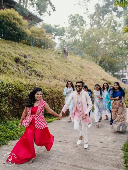 The couple and their friends running down a path, full of energy and excitement.