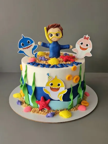 A Baby Shark and scuba diver cake. This 1.5kg lemon blueberry cake features a custom figurine of the birthday boy swimming with his favorite shark characters.