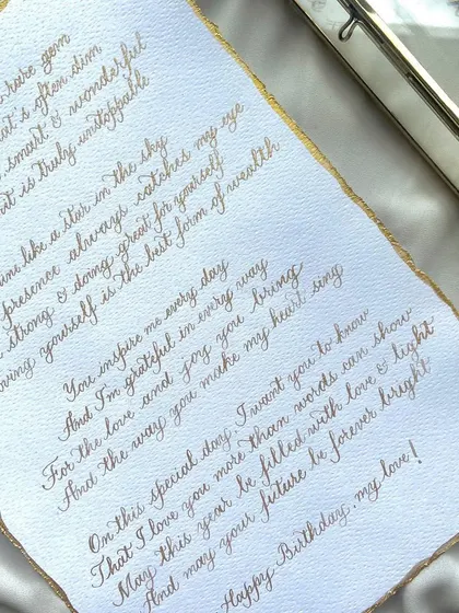 Gold vibes only. A classic white and gold combination for a birthday letter, written in copperplate calligraphy on deckled edge paper with gold gilding. A truly luxurious and personal gift.