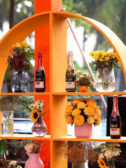 Another view of the decorative shelving, filled with flowers and drinks, serving as both a functional bar and a beautiful decor piece.