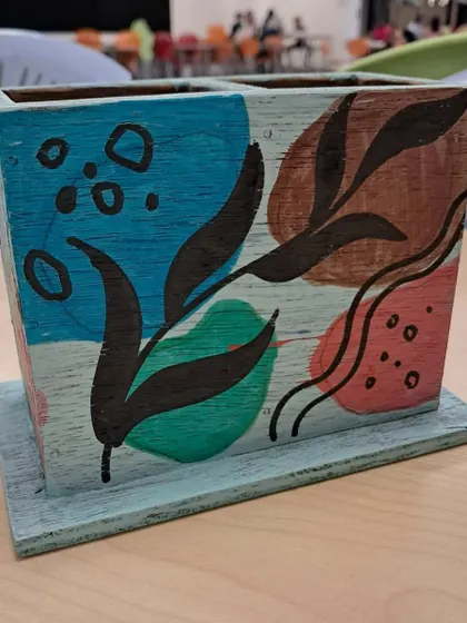 This pencil stand features a lovely mix of earthy tones and bright blues, with playful dots and lines.