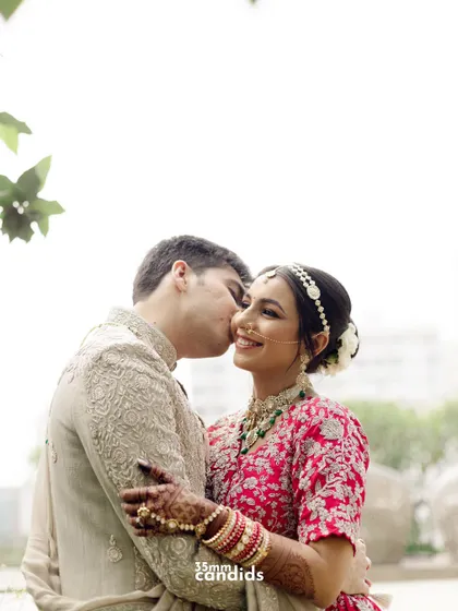 A sweet kiss on the cheek. A simple, classic, and heartwarming portrait of the newlyweds, full of affection.