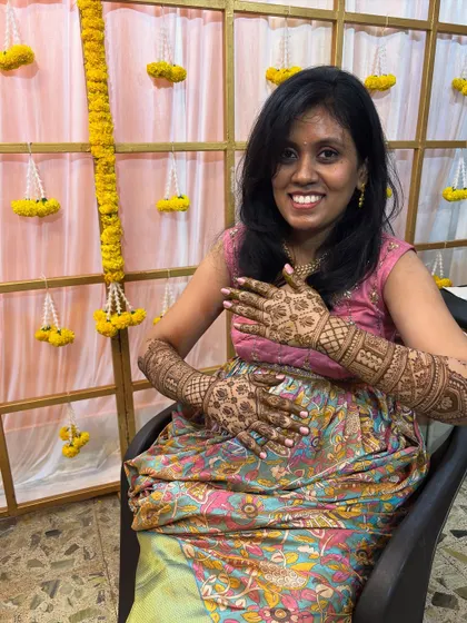 A happy bride-to-be, delighted with her intricate bridal mehendi. Capturing these moments of joy is what I love most about my work.