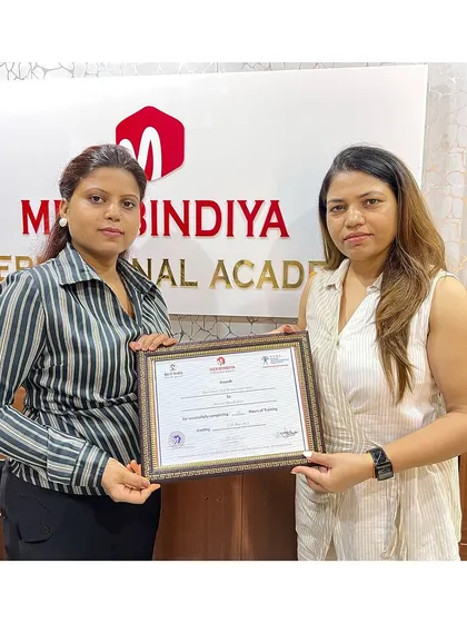 A graduate proudly displays her certificate, a testament to her newly acquired professional skills.