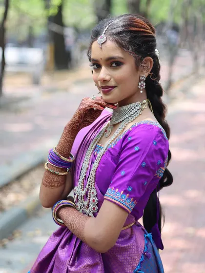 An outdoor bridal portrait where the bride is looking directly at the camera. Her confident pose and beautiful traditional attire make for a powerful shot.
