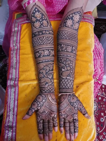 A full-arm design with bold peacock and lotus motifs, creating a striking look.