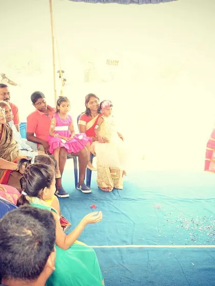 A shot from an outdoor family party, where I'm performing a classic silk production trick. My show is adaptable to any setting, whether it's a large hall or an intimate backyard gathering.